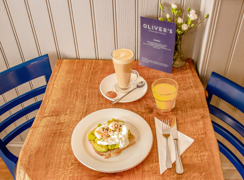 An image of Breakfast setting avocado and eggs at Olivers Coffee Shop